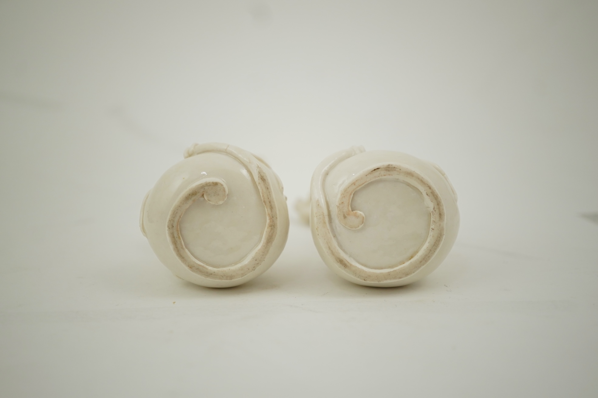 A pair of Chinese blanc-de-chine gourd-shaped vases, Dehua kilns, Qing dynasty